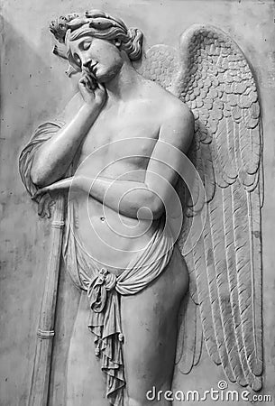Black and white photo showing beautiful dreamer angel carved on a marble wall Editorial Stock Photo