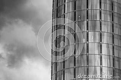 Black and White photo of the skyscraper and a dramatic skies somewhere in London. The miniature statue of Jesus Christ is seen in Stock Photo