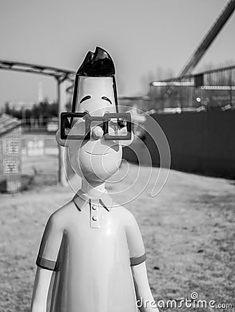 Black and white photo of statue of little head daddy standing in the park Editorial Stock Photo