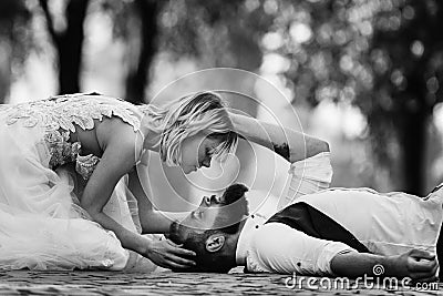 Black and white photo stylish couple in love in the park with blooming cherry or sakura blossoms on background. bearded man and Stock Photo