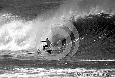 Black and White Photo of a Surfer Surfing Stock Photo
