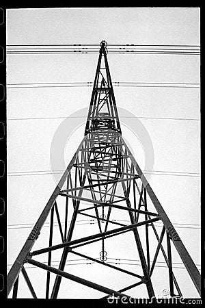 black and white photograph of a power line tower with wires Stock Photo