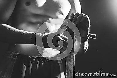 Black white photography of athlete applying tape on the hand Stock Photo