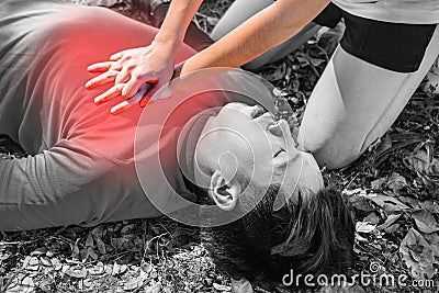 Black and white picture.After Bicycle Race A Cyclist man has Heart Attack or Shock.A woman give CPR for first aid Cyclist man Stock Photo