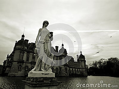 Chateau de Chantilly, Black and White Photograph with Sculpture in Foreground Stock Photo