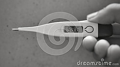 A Black and white picture of a digital farenheit thermometer showing normal body temperature which is 98.6 degree Fahrenheit Stock Photo