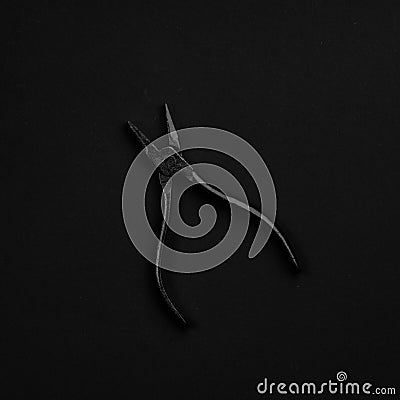 Black & white pliers isolated on black background Stock Photo