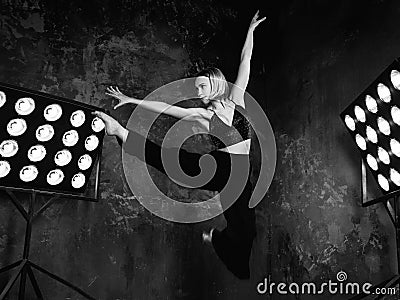 Black and white portrait of beautiful attractive blonde young woman dancer on the stage Stock Photo