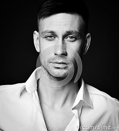 Black and white portrait of calm friendly brunette man in unbuttoned formal shirt office worker Stock Photo