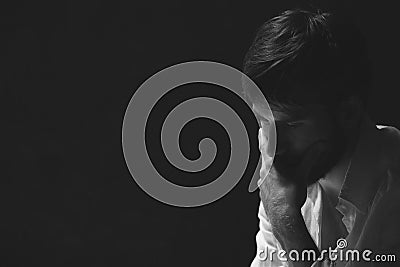 Black and white portrait of worried man, photo with copy space on dark background Stock Photo