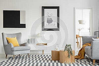 Black and white poster of dog on the wall of fashionable living room interior with two wooden coffee tables with flowers Stock Photo