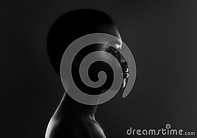 Black And White Profile Shot Of Beautiful African Female Over Dark Background Stock Photo