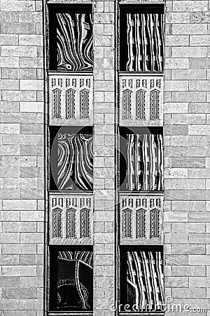 Black and white rendering of art deco building with abstract reflections in six windows - close-up Stock Photo