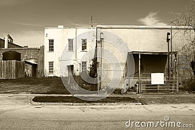 black white sepia deserted town industrial war abandoned closed shut run-down buildings Stock Photo