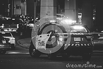 Black and white shot of the backend of a Toronto Police Service with emergency lights activated Editorial Stock Photo