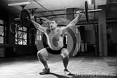 Black And White Shot Of Man In Gym Lifting Weights Stock Photo