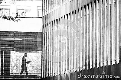 Silhouette of a man reading a newspaper in the architecture of the city Stock Photo