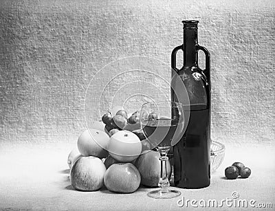 Black and white still-life with wine and fruit Stock Photo