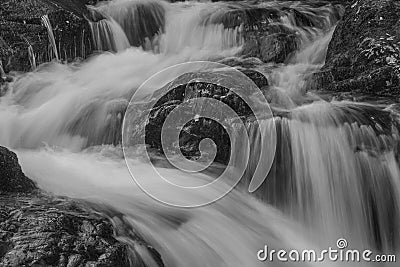 Black and white Stunning vibrant landscape image of Aira Force Upper Falls in Lake District during colorful Autumn showing Stock Photo