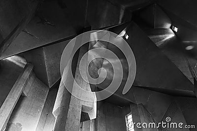 Detail of rough raw concrete ceiling with abstract geometric patterns of brutalist architecture. Stock Photo