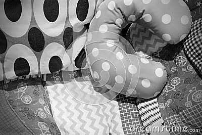 Black and white u-shaped pillows on the patterned cushion Stock Photo