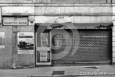 Streetscape view of a boarded shop front on a high street Editorial Stock Photo