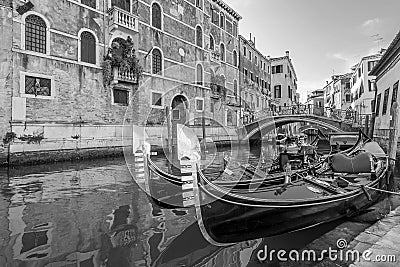 Black and white view of Typical gondolas parked in a Venetian canal, Venice, Italy Stock Photo