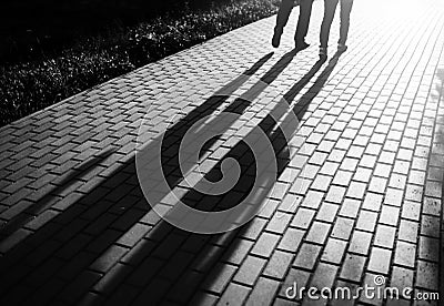 Black and white walking couple in sunset park bokeh backdrop Stock Photo