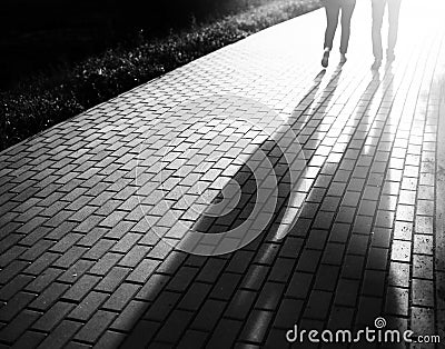 Black and white walking couple in sunset park bokeh backdrop Stock Photo