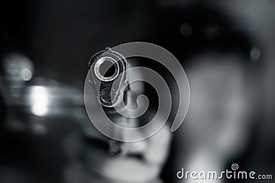 Black and white, woman pointing a old gun to front with one Hand Stock Photo