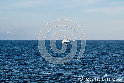 Black and White Yacht on Horizon Stock Photo