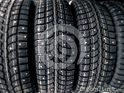 Winter wheel tyres. Black winter studded tires in store Stock Photo