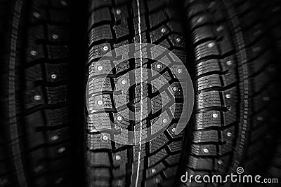 Winter tires stack closeup. Black winter studded tires in store Stock Photo