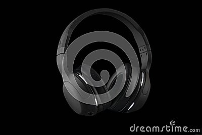 Black wireless headphones isolated on a black background Stock Photo