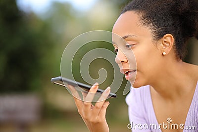 Black woman dictating message on phone Stock Photo