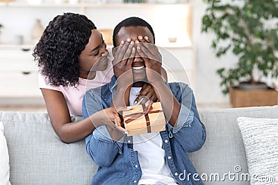 Black woman giving her boyfriend birthday gift Stock Photo