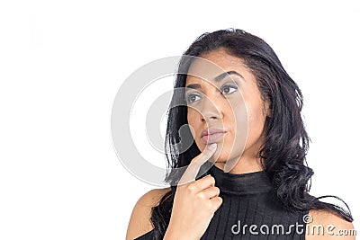 Black woman is with her finger on her chin and thinking of what Stock Photo
