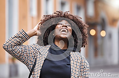 Black woman, laughing and afro hair in city fun, goofy or silly travel in urban New York or holiday location. Smile Stock Photo