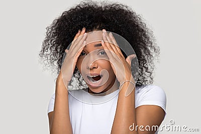 African female cover face with hand feels afraid studio shot Stock Photo