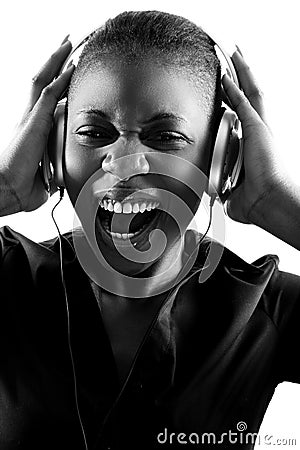 Black woman singing to music on headphones Stock Photo