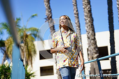 Black woman walking outoors working full time with selfie pictures for social media Stock Photo