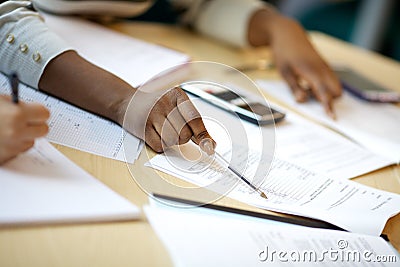 Black woman works through spreadsheets in meeting Stock Photo