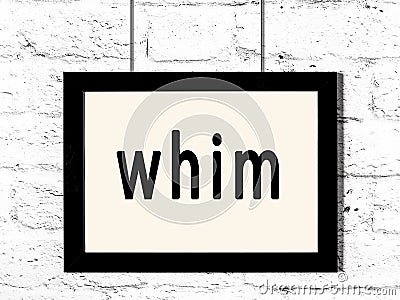 Black frame hanging on white brick wall with inscription whim Stock Photo