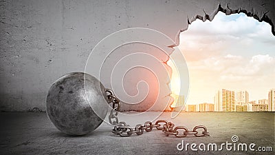 A black wrecking ball and hole in a concrete wall showing city landscape. Stock Photo