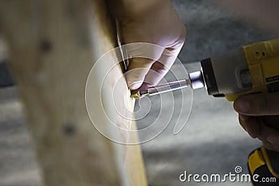 Black and yellow cordless drill in man hand Stock Photo