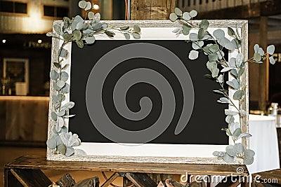 Blackboard Framed with Leaves at Event Stock Photo