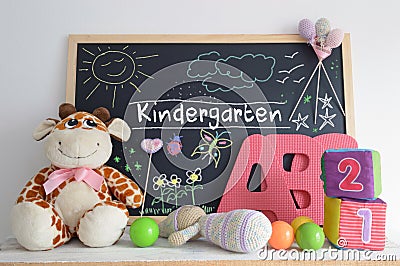 Blackboard in a kindergarten classroom and some baby stuff. Stock Photo