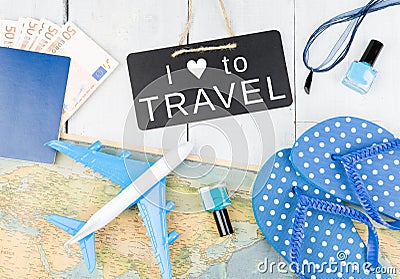 blackboard with text & x22;I LOVE TO TRAVEL& x22;, plane, map, passport, money, flops and other accessories Stock Photo