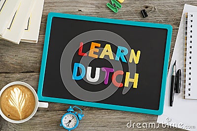 Blackboard on wooden table with Learn Dutch recommendation from plastic letters Stock Photo