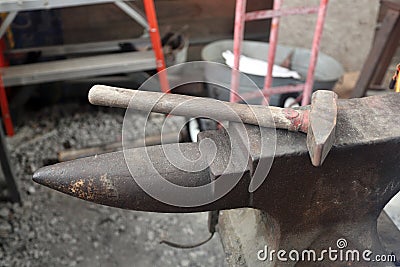 Blacksmith anvil and hammer in workshop Stock Photo